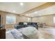 Finished basement featuring a plush couch, television, and a ping pong table at 15635 Dawson Creek Dr, Monument, CO 80132