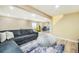 Finished basement featuring a plush couch, television, and an arcade game at 15635 Dawson Creek Dr, Monument, CO 80132