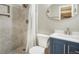 Bathroom featuring a modern sink, toilet, and shower with tile surround at 15635 Dawson Creek Dr, Monument, CO 80132
