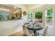 Cozy dining area with large windows and modern furnishings and access to the kitchen at 15635 Dawson Creek Dr, Monument, CO 80132