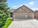 Charming home with a three-car garage, well-maintained lawn, and mature trees at 15635 Dawson Creek Dr, Monument, CO 80132