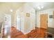 Bright entry foyer with hardwood floors and multiple closets and entryways at 15635 Dawson Creek Dr, Monument, CO 80132