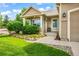 Home with well-manicured front yard, lush landscaping, and inviting entrance at 15635 Dawson Creek Dr, Monument, CO 80132