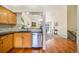 Open concept kitchen with stainless steel appliances, wooden cabinets and views into the Gathering room at 15635 Dawson Creek Dr, Monument, CO 80132