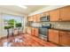Bright kitchen with stainless steel appliances, breakfast nook, and hardwood floors at 15635 Dawson Creek Dr, Monument, CO 80132