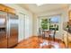 Bright eat-in kitchen with stainless steel appliances, wood floors, and a view of the landscaped yard at 15635 Dawson Creek Dr, Monument, CO 80132