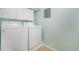 Functional laundry area with white appliances, ample cabinet space, and a practical layout for efficient laundry tasks at 15635 Dawson Creek Dr, Monument, CO 80132