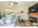 Comfortable living space boasts a fireplace, TV, and views into the bright kitchen and dining area at 15635 Dawson Creek Dr, Monument, CO 80132
