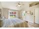 Spacious main bedroom features wood floors, vaulted ceilings, a window with backyard views, and an ensuite at 15635 Dawson Creek Dr, Monument, CO 80132