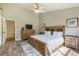 Comfortable main bedroom with a wooden bed frame, wood flooring, and a calming color scheme creating a relaxing retreat at 15635 Dawson Creek Dr, Monument, CO 80132
