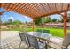 Outdoor patio with a wooden pergola over a table with seating, ideal for outdoor dining at 15635 Dawson Creek Dr, Monument, CO 80132