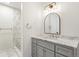 Bathroom vanity with stone countertop, decorative mirror and updated lighting at 1336 Sable Blvd, Aurora, CO 80011