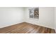 Cozy bedroom with wood-look floors and a large window bringing in natural light at 1336 Sable Blvd, Aurora, CO 80011