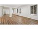 Bright bedroom with wood-look floors, mirrored closet doors, and natural light from two large windows at 1336 Sable Blvd, Aurora, CO 80011