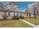 Charming single-story home with a brick and siding facade, complemented by a well-manicured lawn at 1336 Sable Blvd, Aurora, CO 80011