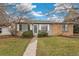 A inviting home with a well-manicured front yard, complemented by brick and siding at 1336 Sable Blvd, Aurora, CO 80011