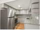 Updated kitchen with stainless appliances, gray cabinets, granite countertops, and unique backsplash at 1336 Sable Blvd, Aurora, CO 80011