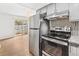 Stylish kitchen featuring stainless steel appliances, stone countertops, and outdoor access at 1336 Sable Blvd, Aurora, CO 80011