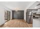 Open-concept living space with stylish flooring, modern accents, and stainless steel kitchen appliances at 1336 Sable Blvd, Aurora, CO 80011