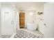 Bright bathroom featuring standalone tub, walk-in shower with glass door and patterned floor at 1590 Little Raven St # 702, Denver, CO 80202