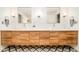 Bright bathroom featuring double sinks with wood cabinets and patterned floor at 1590 Little Raven St # 702, Denver, CO 80202