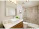 Modern bathroom with glass shower, sleek vanity, square mirror and contemporary fixtures at 1590 Little Raven St # 702, Denver, CO 80202