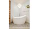 Bright bathroom featuring a modern standalone tub, wooden cabinet, and tiled floor at 1590 Little Raven St # 702, Denver, CO 80202
