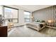 Well-lit bedroom showcases an accent wall, large windows, and elegant furniture at 1590 Little Raven St # 702, Denver, CO 80202