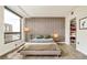 Bright bedroom with a feature wall, large windows, and a closet with organized storage at 1590 Little Raven St # 702, Denver, CO 80202