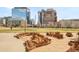 Inviting city park with lush green space, brick trim, and city buildings in the background at 1590 Little Raven St # 702, Denver, CO 80202