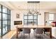 Bright dining room featuring a modern chandelier, a fireplace, and large windows with city views at 1590 Little Raven St # 702, Denver, CO 80202