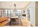 Bright dining room featuring a modern chandelier, a fireplace, and large windows with city views at 1590 Little Raven St # 702, Denver, CO 80202