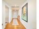 Hallway featuring hardwood floors, artwork, and a view into another room at 1590 Little Raven St # 702, Denver, CO 80202