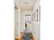 Hallway featuring wood floors, white walls, and a rug leading to another room at 1590 Little Raven St # 702, Denver, CO 80202