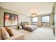 Spacious main bedroom with large windows, chandelier, and neutral color palette at 1590 Little Raven St # 702, Denver, CO 80202