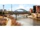 Scenic river view with bridge, walking path, and surrounding cityscape at 1590 Little Raven St # 702, Denver, CO 80202