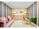 Sitting room featuring a modern sofa, desk, and cabinetry with colorful wallpaper at 1590 Little Raven St # 702, Denver, CO 80202