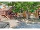 Multi-level brick home featuring mature trees, dark brown wood balconies and stairs at 1885 S Quebec Way # H15, Denver, CO 80231