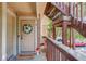 Inviting front door with decorative wreath, welcome mat, and a small American flag at 1885 S Quebec Way # H15, Denver, CO 80231