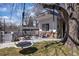 Spacious backyard featuring swing set, mature trees, and seating, creating a relaxing and playful outdoor space at 1400 E Bates Ave, Englewood, CO 80113