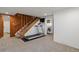 Finished basement with treadmill, stairs, and visible laundry room at 1400 E Bates Ave, Englewood, CO 80113