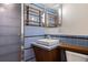 Bathroom featuring blue tiling, a modern sink, and wood accents at 1400 E Bates Ave, Englewood, CO 80113