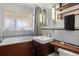 Bathroom featuring a modern sink, wood accents, and tub with shower at 1400 E Bates Ave, Englewood, CO 80113