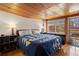 Cozy bedroom featuring a quilt, hardwood floors, and a wood paneled ceiling at 1400 E Bates Ave, Englewood, CO 80113