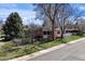 Lovely single-story home with a brick exterior, mature trees and verdant front lawn at 1400 E Bates Ave, Englewood, CO 80113