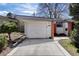 This single-story home features an attached garage with a well-maintained driveway and landscape at 1400 E Bates Ave, Englewood, CO 80113