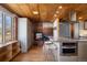Modern kitchen featuring a brick fireplace, custom cabinets, and an island with seating, creating a cozy atmosphere at 1400 E Bates Ave, Englewood, CO 80113