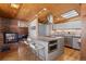 Modern kitchen featuring a brick fireplace, custom cabinets, and an island with seating, perfect for entertaining at 1400 E Bates Ave, Englewood, CO 80113