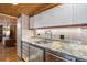 Kitchen with stainless steel appliances, granite countertops, and elegant backsplash, offering a sleek design at 1400 E Bates Ave, Englewood, CO 80113