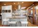 Bright, modern kitchen with granite countertops, stainless steel appliances, and cozy breakfast bar seating at 1400 E Bates Ave, Englewood, CO 80113